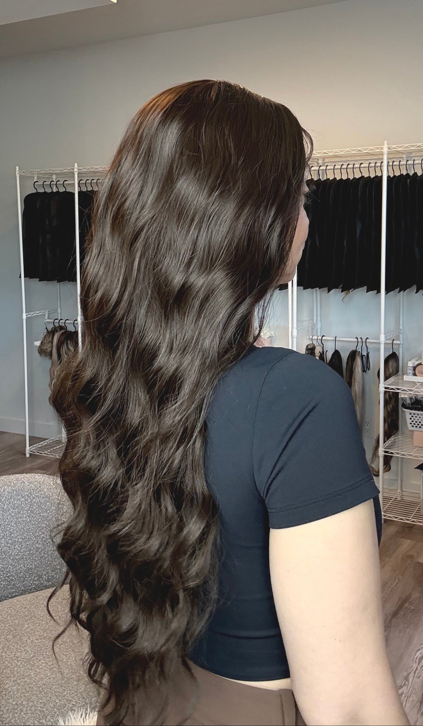 Person with long, wavy hair in a hair salon setting