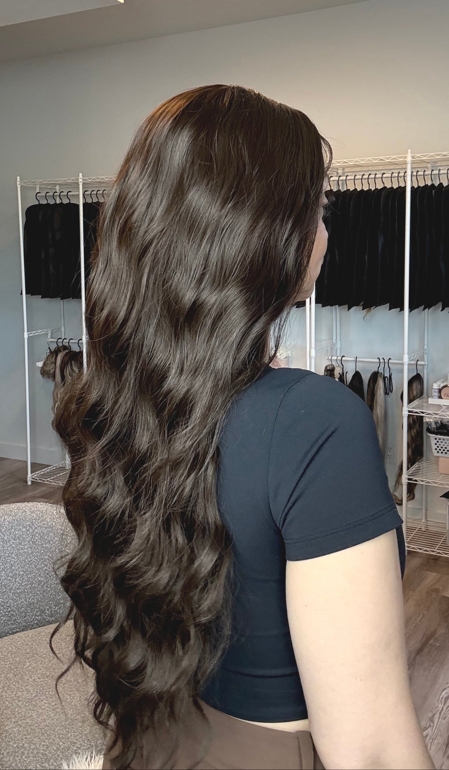 Person with long, wavy hair in a hair salon setting