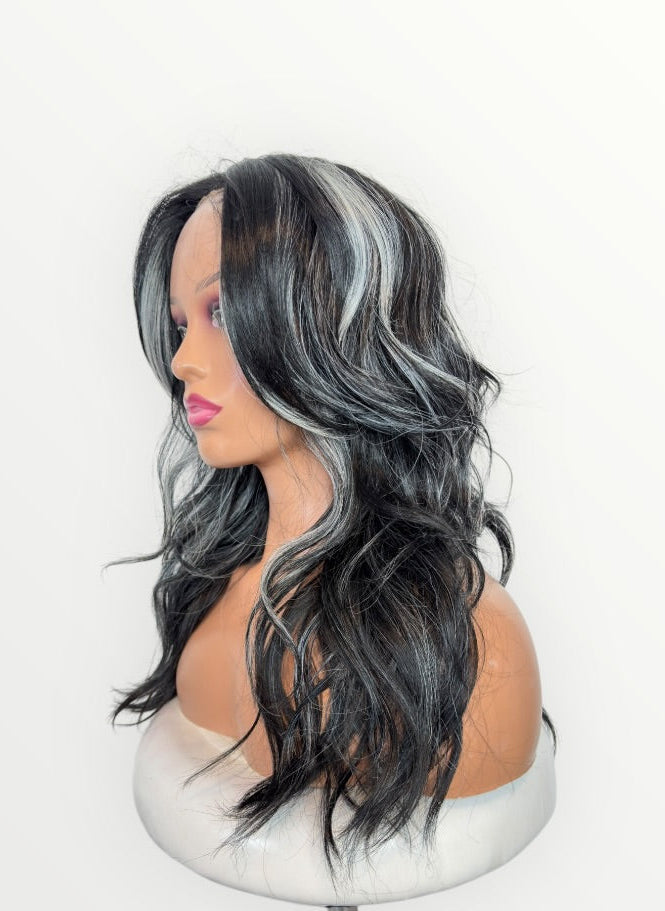 Black and gray wig on a mannequin head against a white background