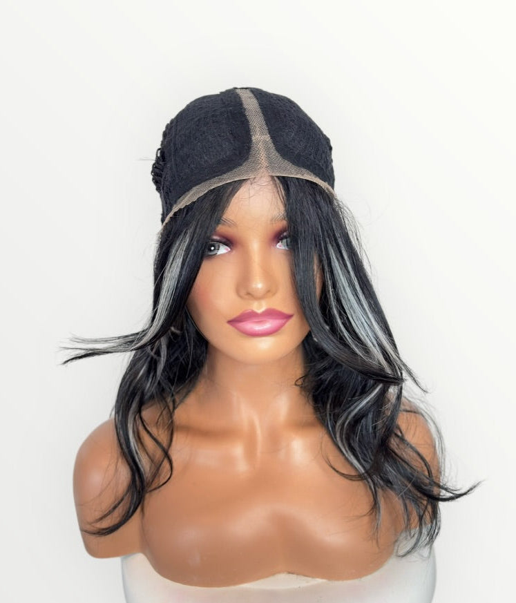 Mannequin head with a black and gray wig on a white background