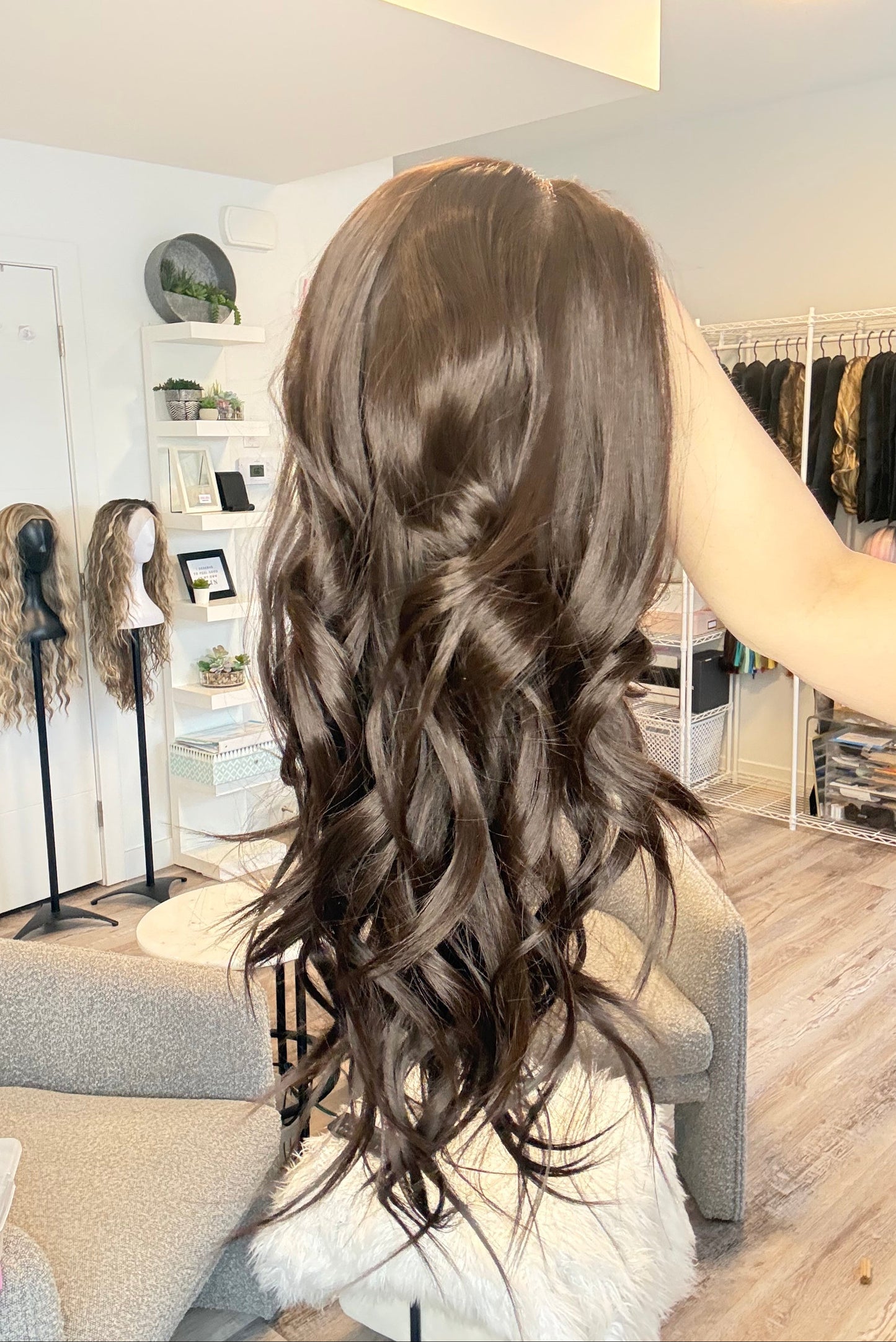 Person with long, wavy hair in a salon setting