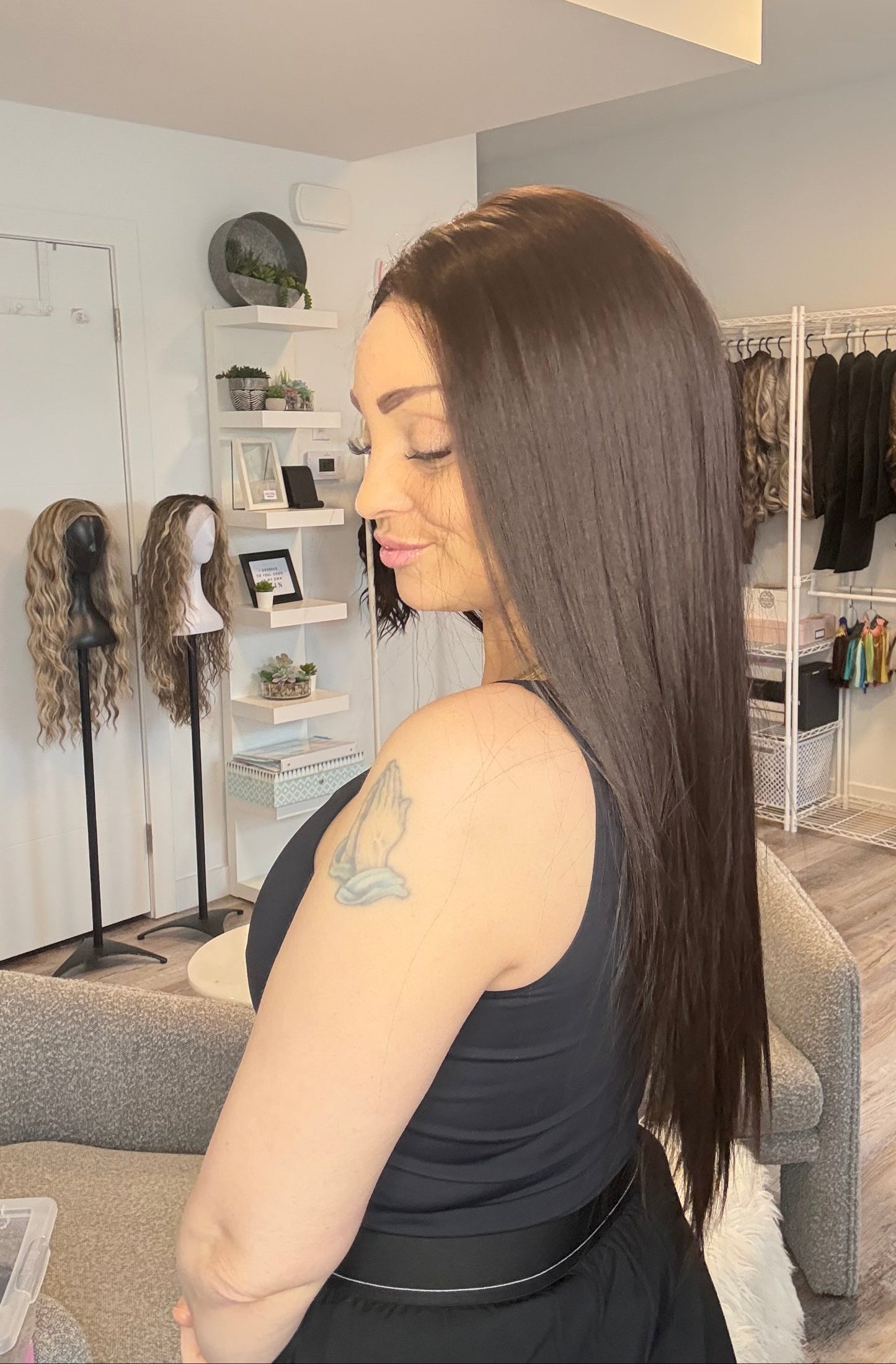 Woman with long hair in a room with shelves and decor