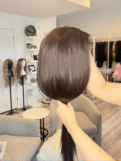 Mannequin head with brown hair in a hair salon setting