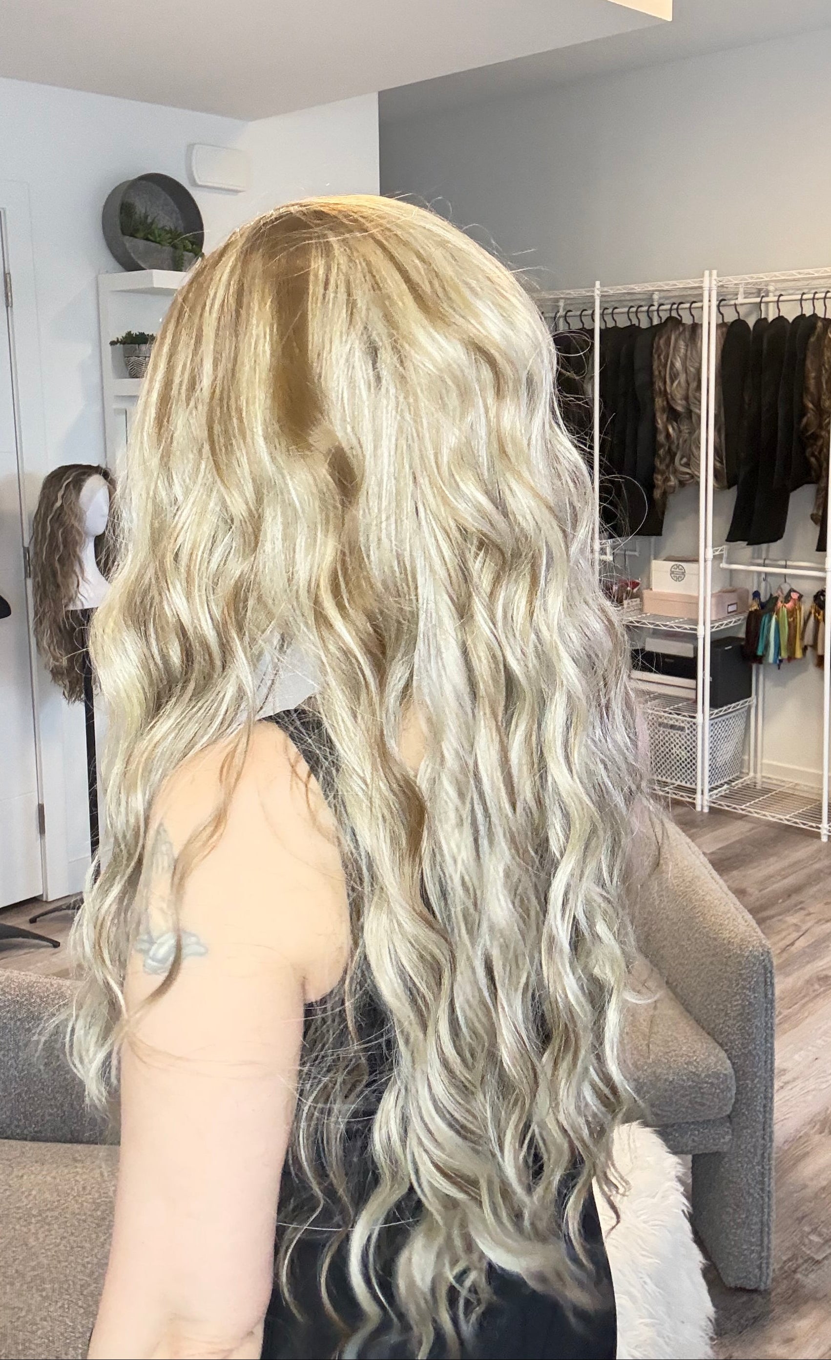 Person with long blonde hair in a salon setting