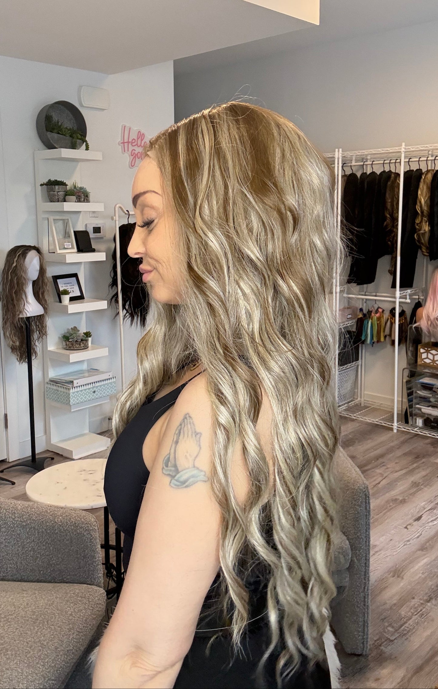 Person with long, wavy hair in a salon setting