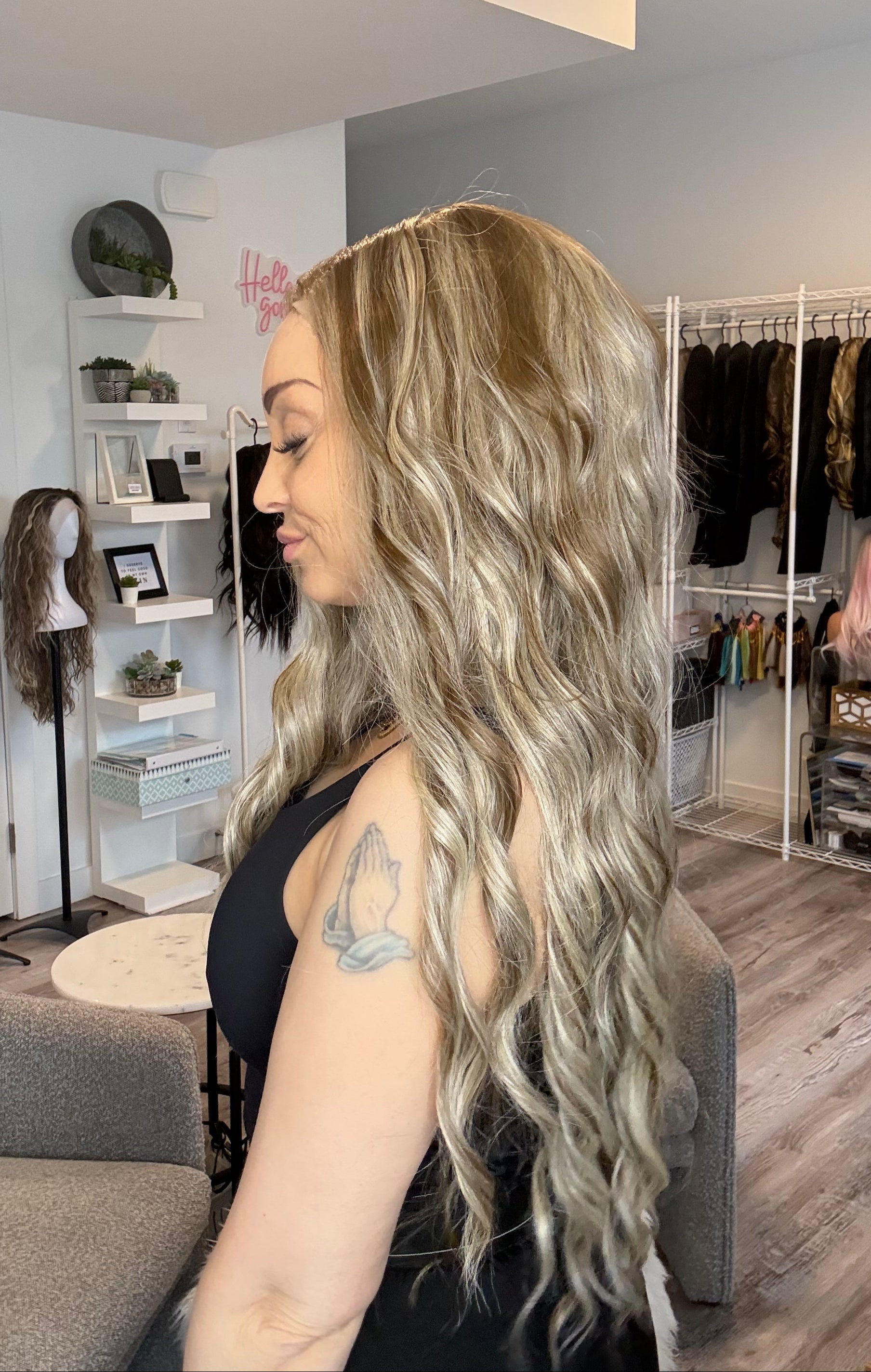 Person with long, wavy hair in a salon setting