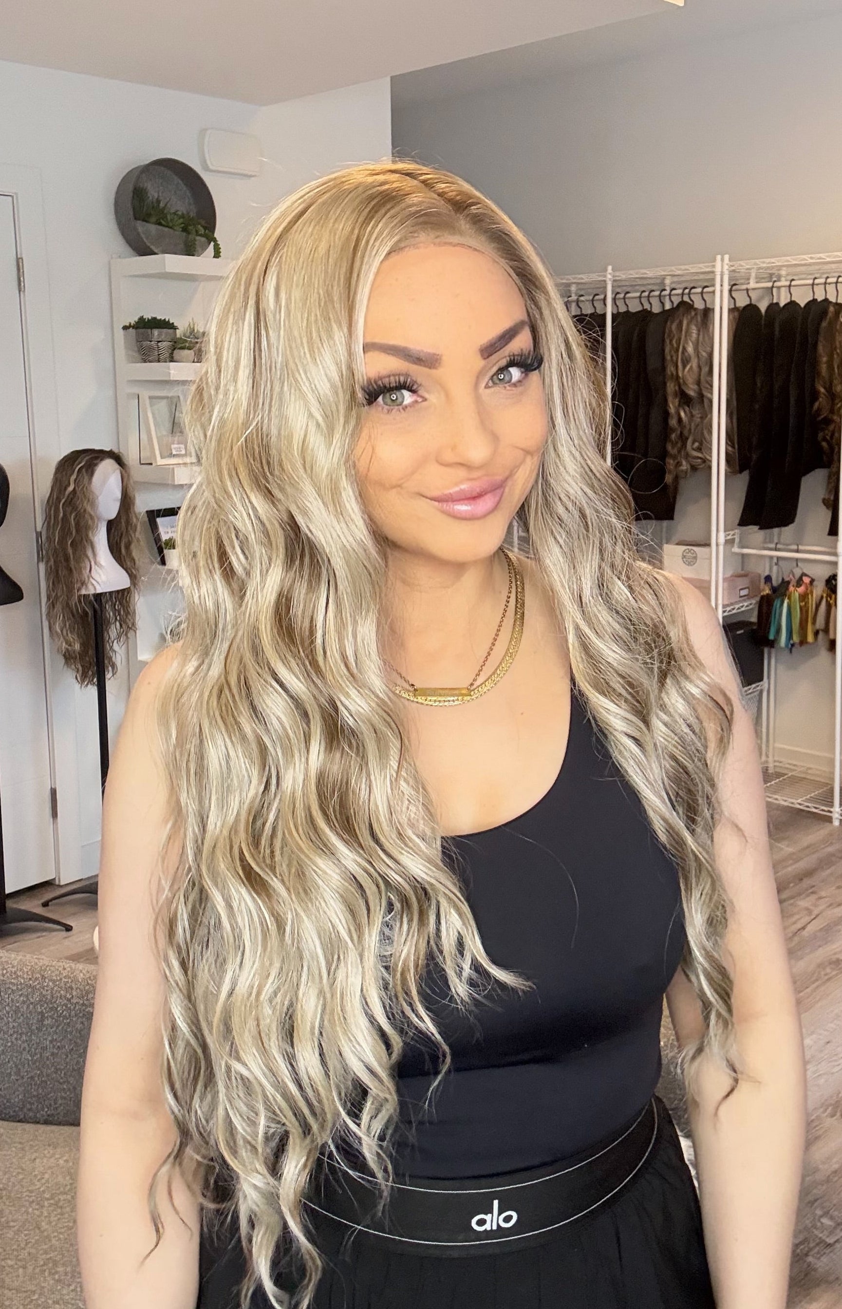 Woman with long blonde wig in a clothing store setting