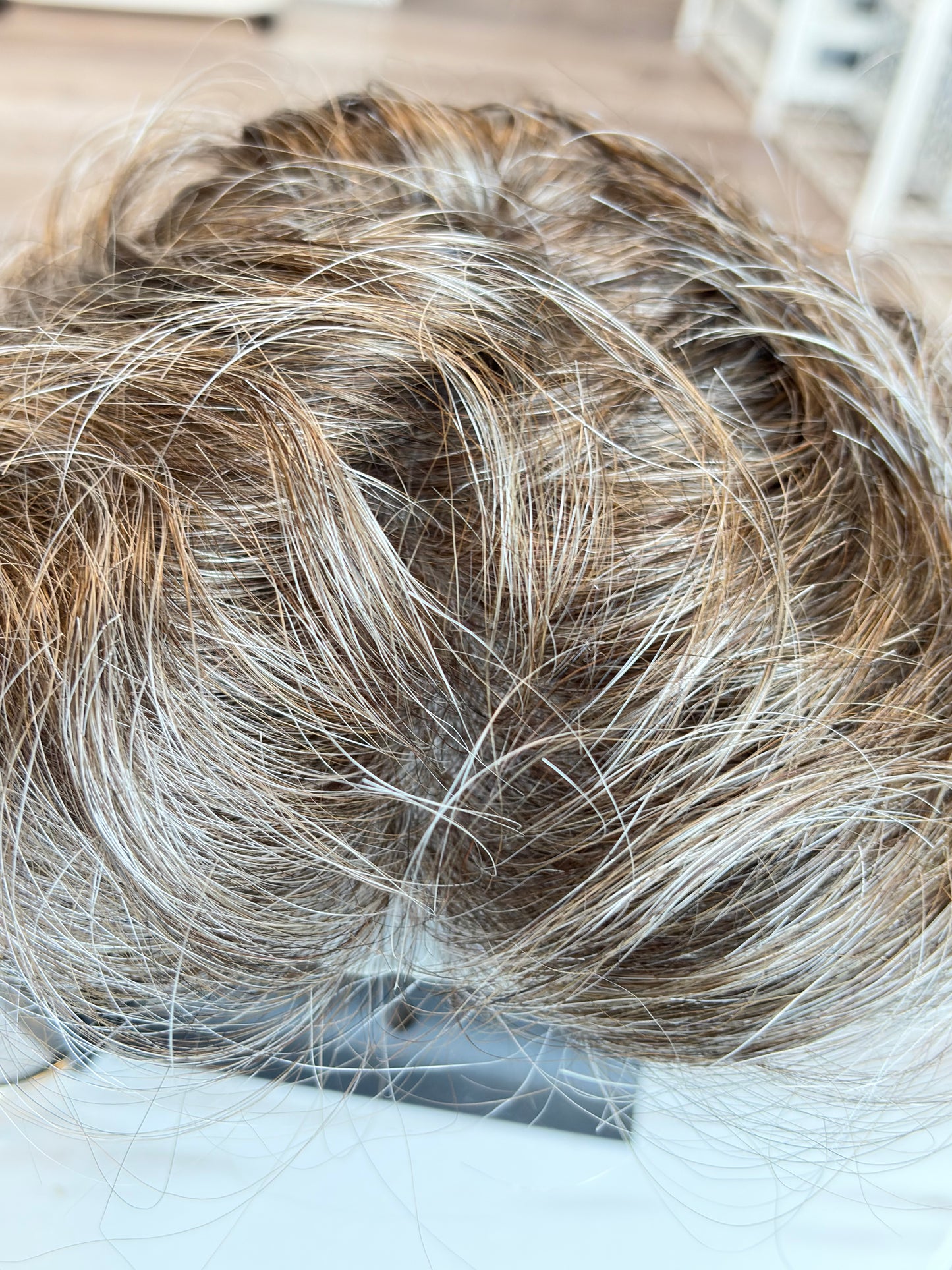 Close-up of a ball of brown and gray hair extensions.