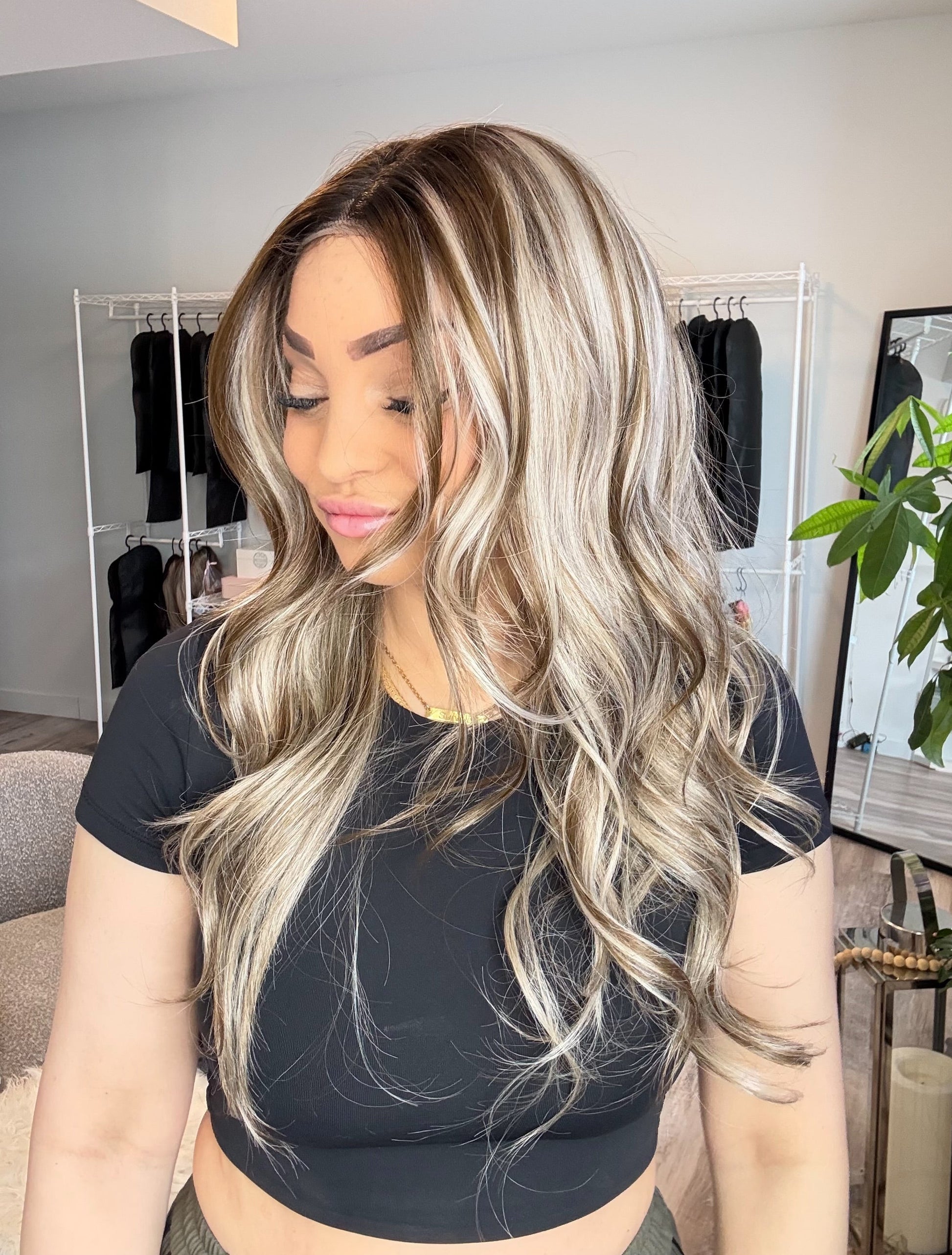 Person with long, wavy hair styled in a salon setting