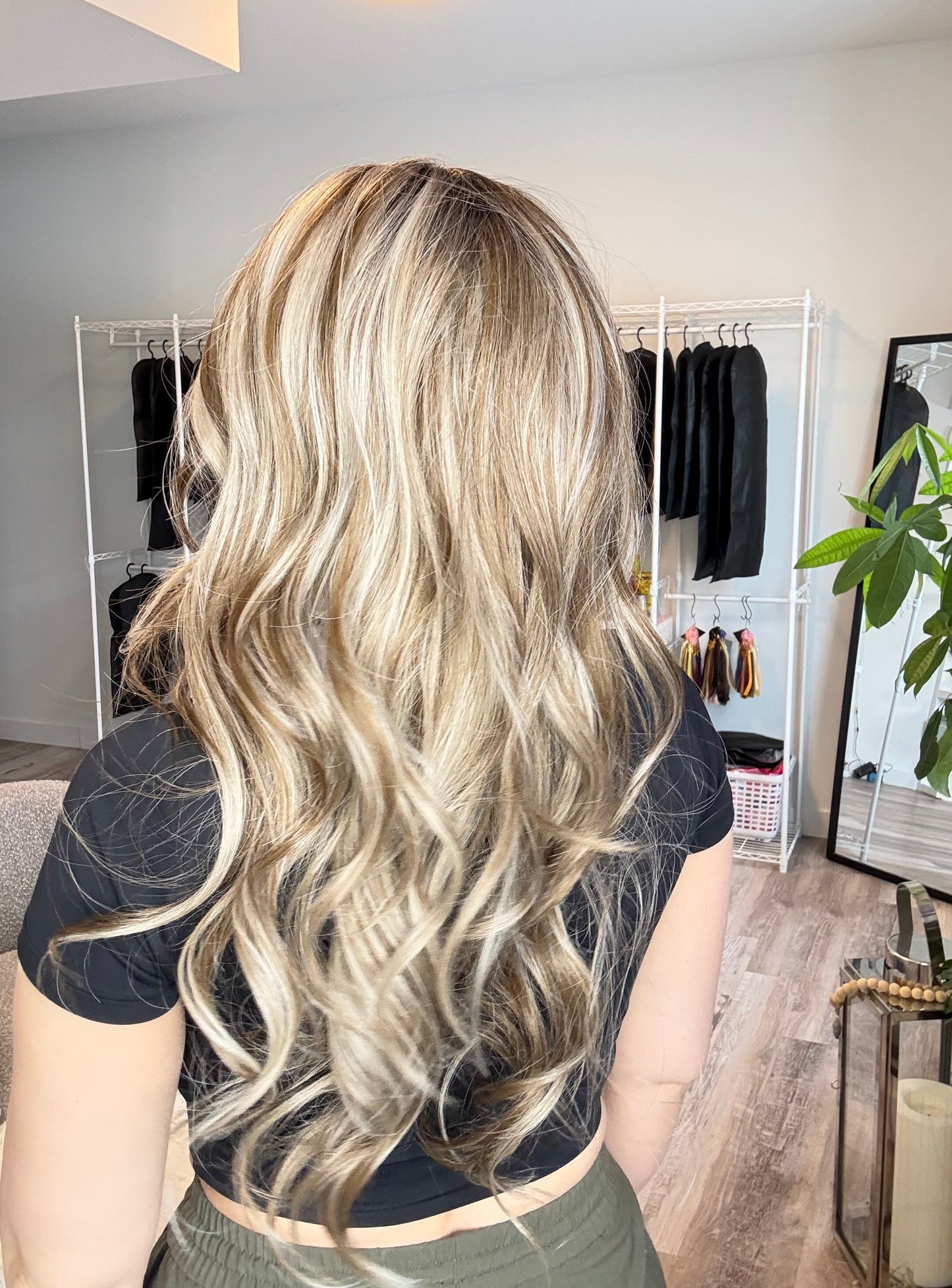Person with long blonde hair in a salon setting