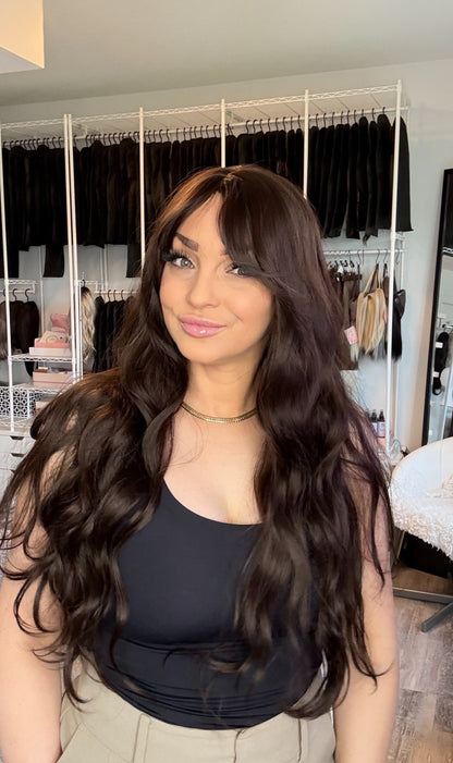 Megan rich brunette wig with curtain bangs and long flowing waves, Everyday Ready non-lace wig, The Wig Spa Canada