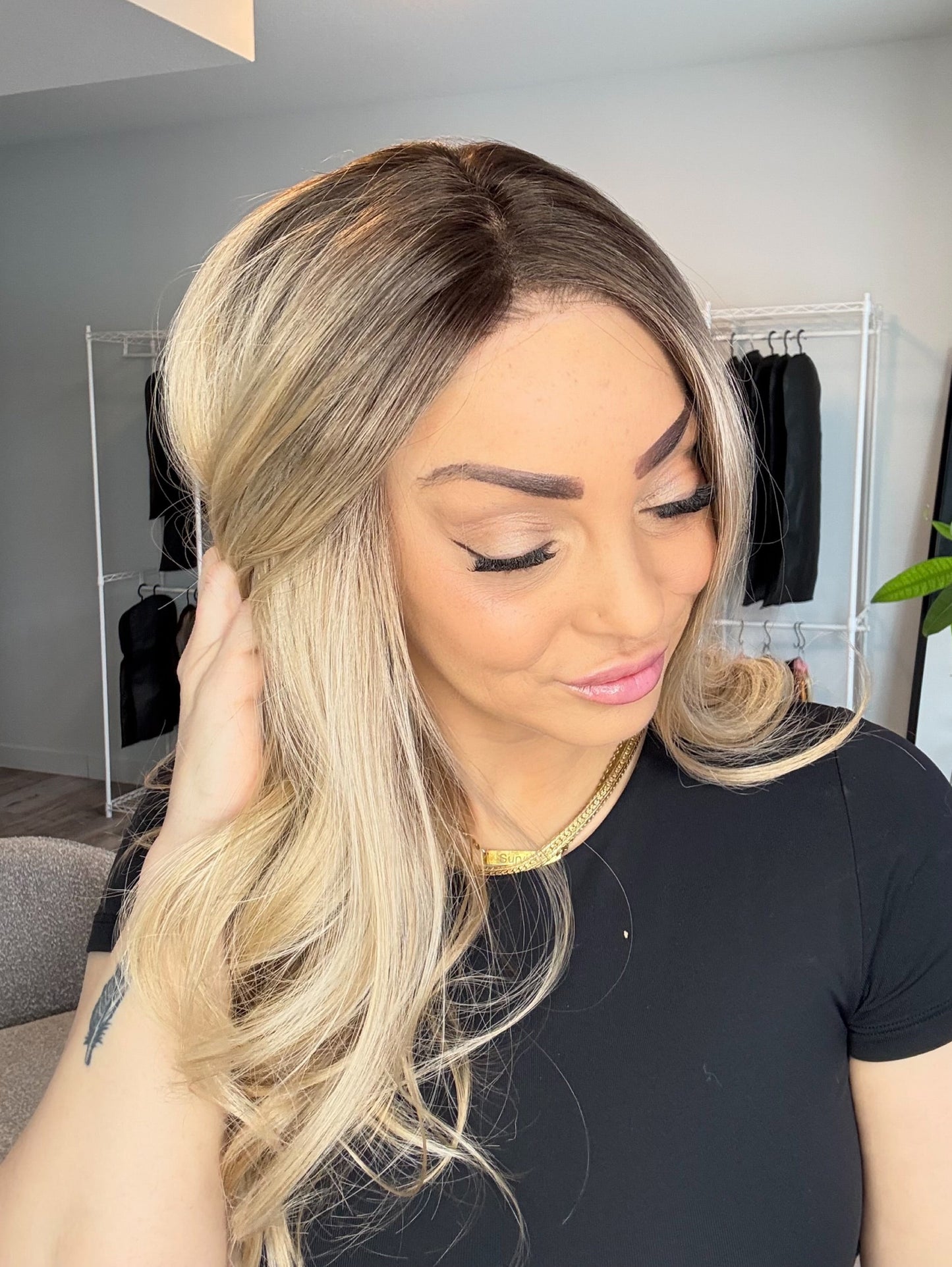 Woman with blonde hair looking at herself in a mirror