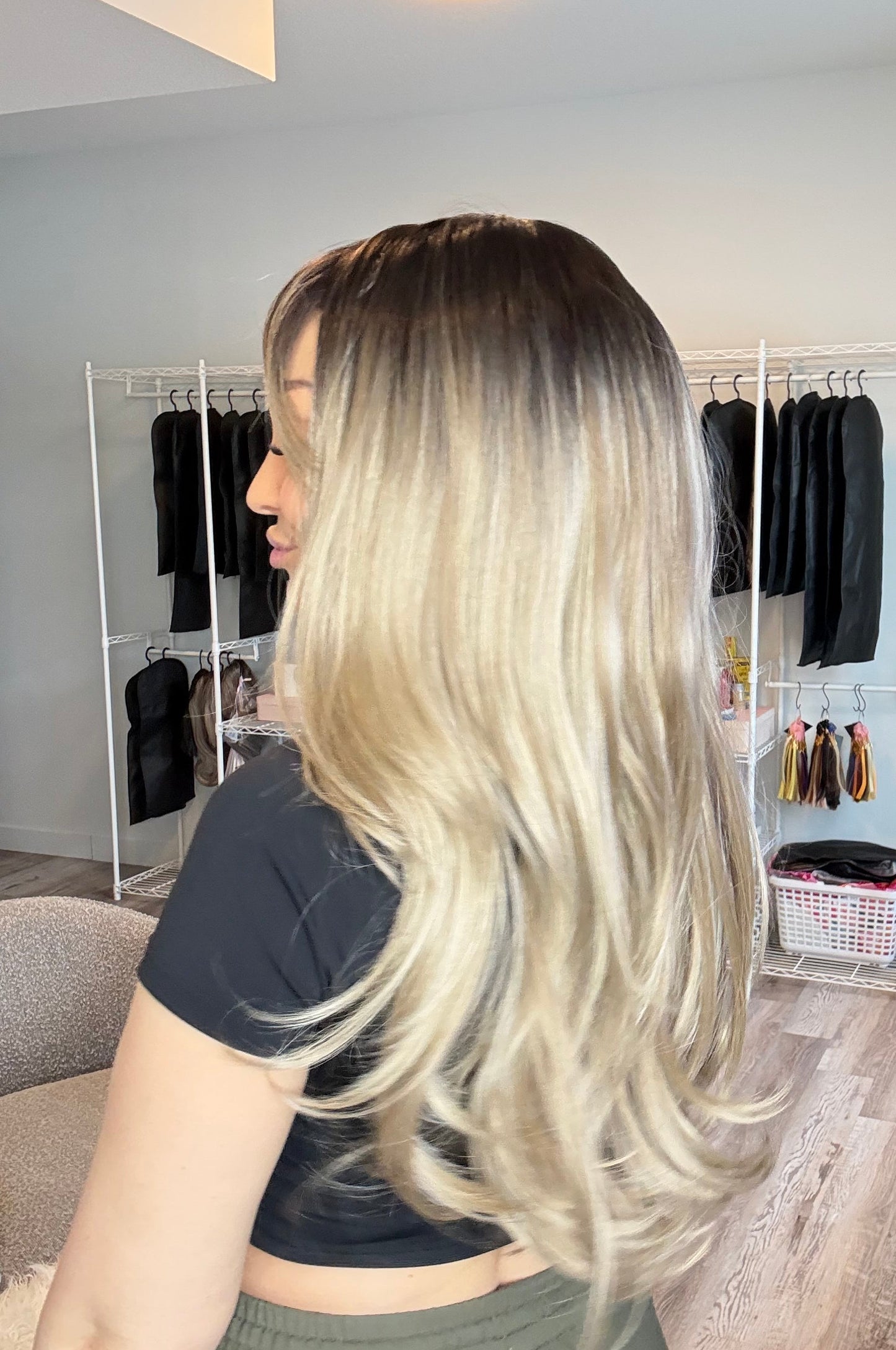 Person with long blonde hair in a salon setting