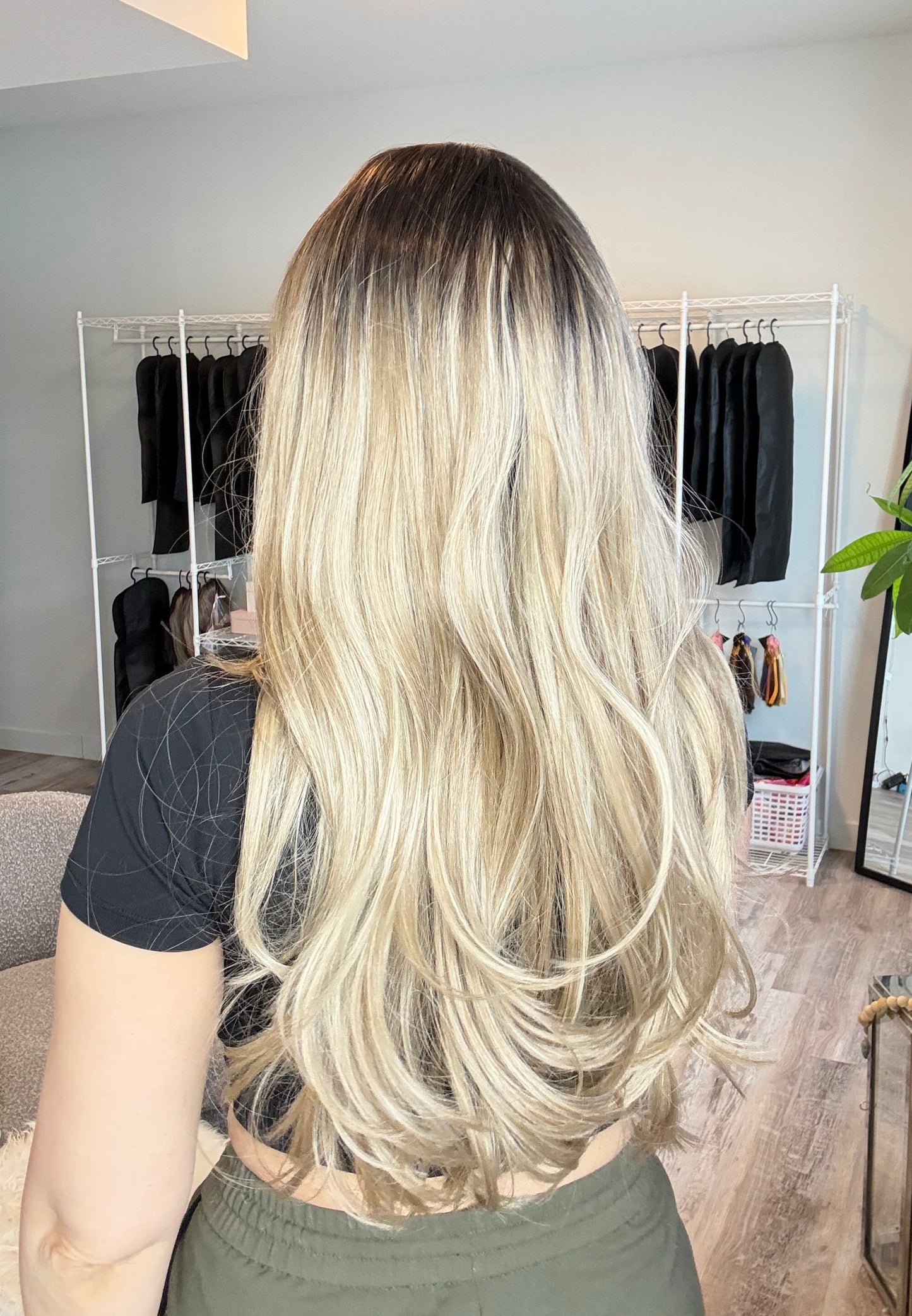 Person with long blonde hair in a salon setting
