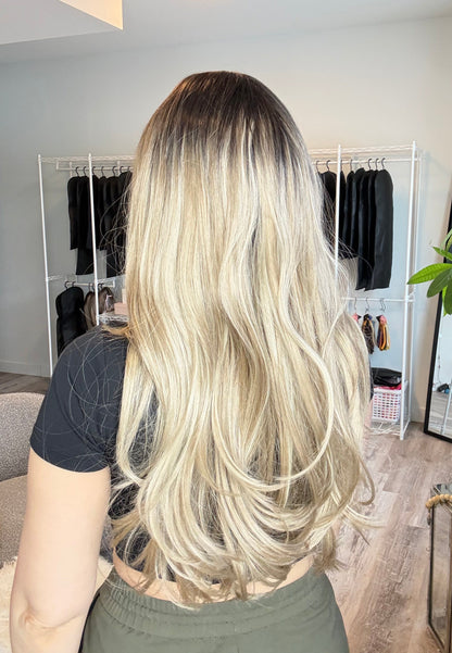 Person with long blonde hair in a salon setting