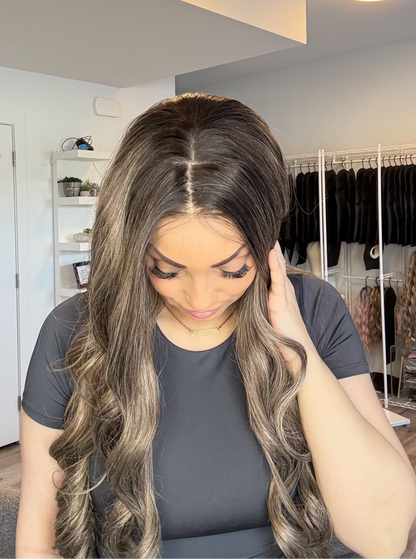Woman with long, wavy hair in a room with a closet and shelves.