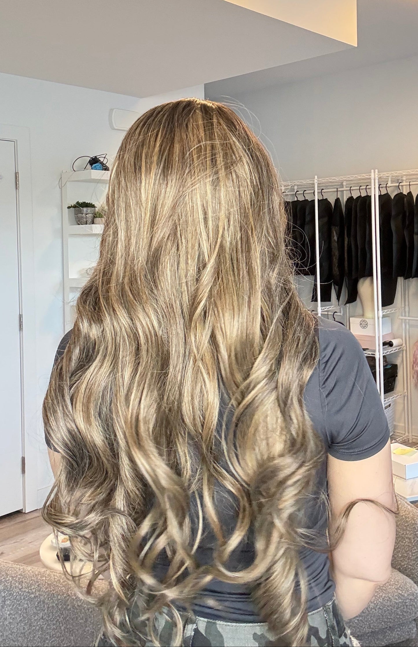 Person with long, wavy hair in a salon setting