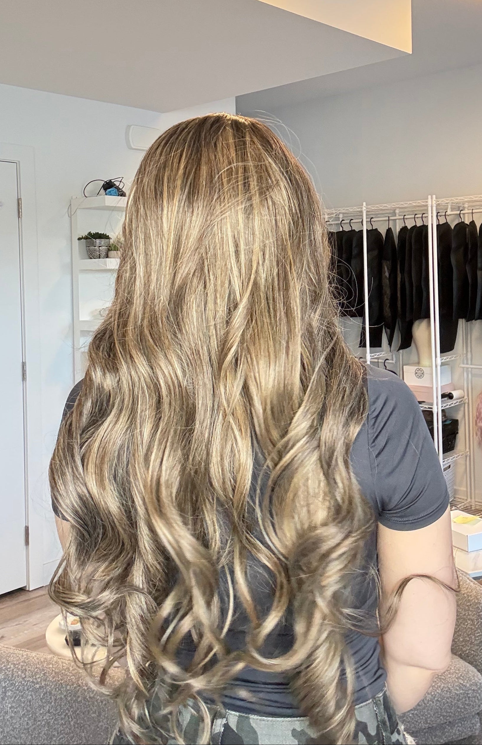 Person with long, wavy hair in a salon setting