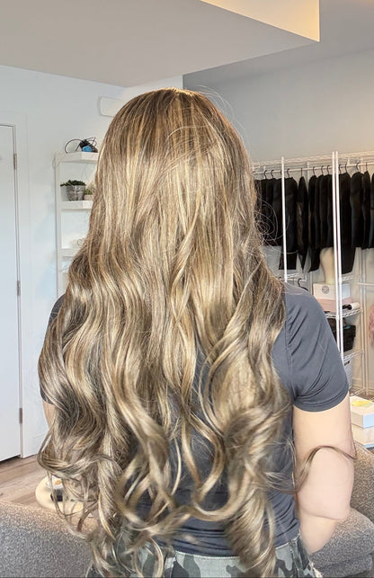 Person with long, wavy hair in a salon setting