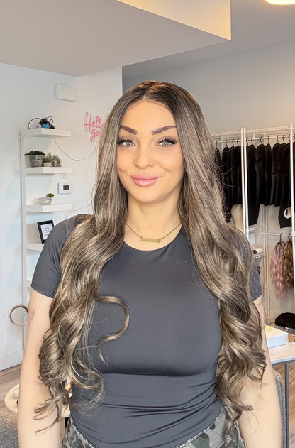 Woman with long, wavy hair in a clothing store