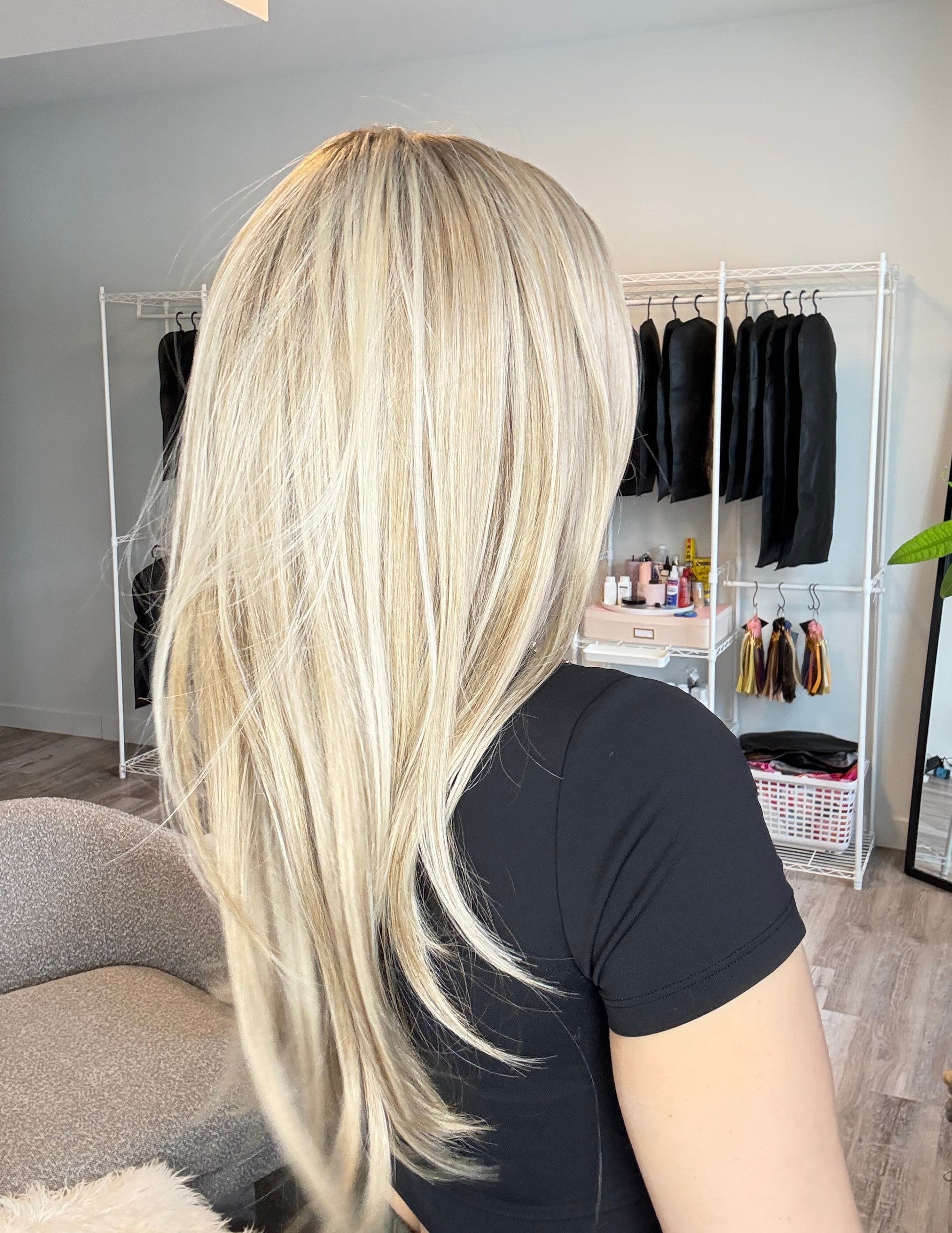 Person with long, blonde hair in a salon setting